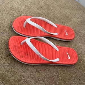 Orange Nike flip flops